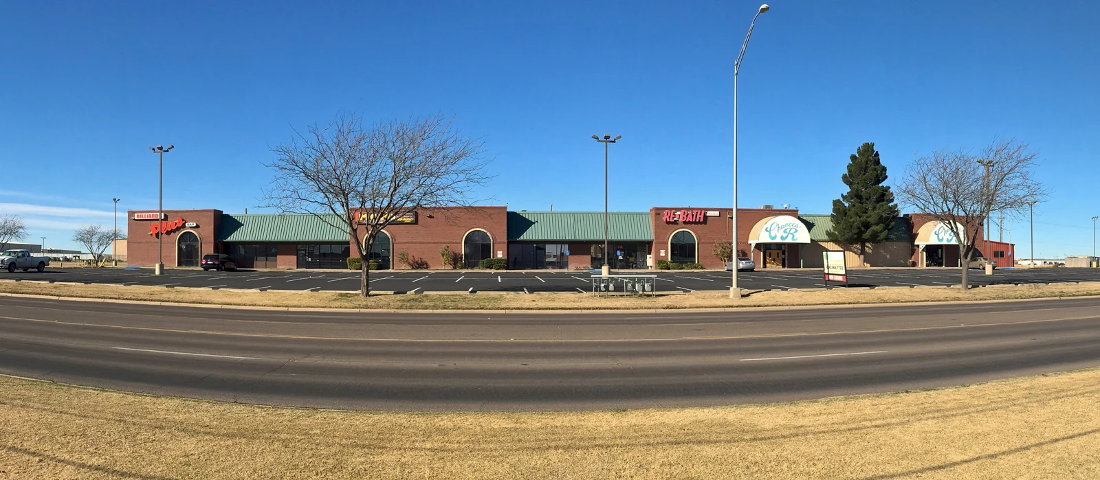 The brick storefronts and green roof accents of Frankford Center, photographed in 2016