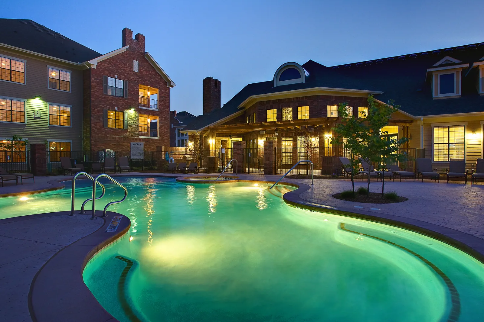 The Windsor Creek Apartments pool and clubhouse at dusk